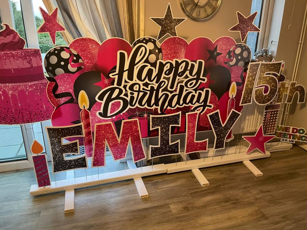 Happy 15th Birthday Emily in pink glitter letters indoors
