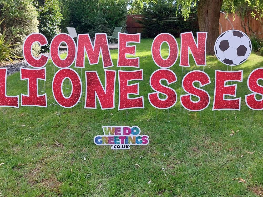 Come On Lionesses in red glitter letters with a football