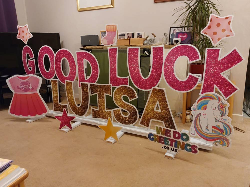 Good Luck Luisa in glitter letters in a living room