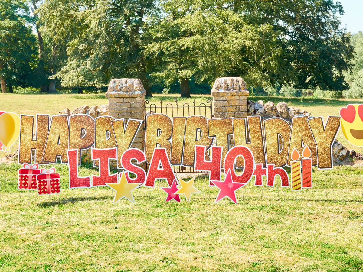 Lisa 40th in pink glitter letters with balloons and emoji on a lawn